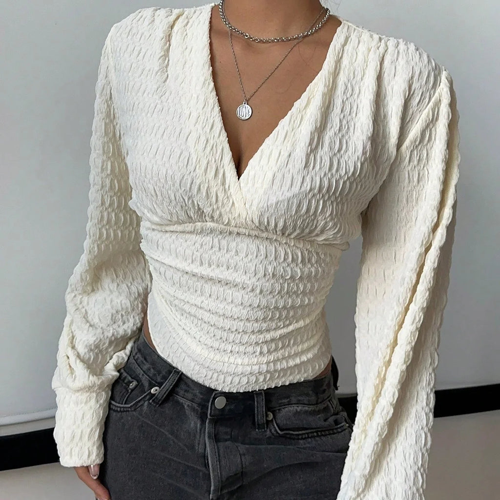 A tight long-sleeved knitted jumpsuit with a small V-neck for women