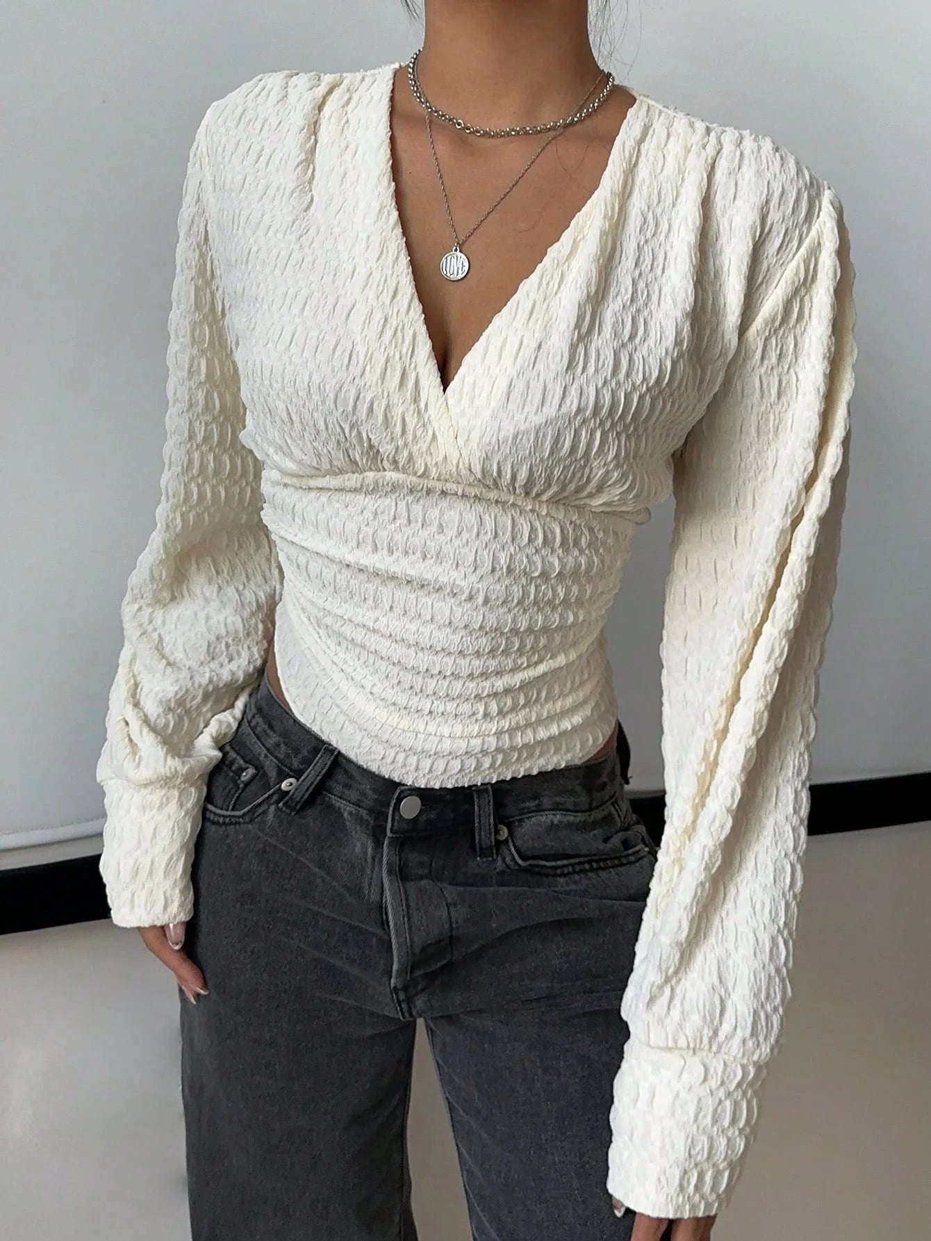 A tight long-sleeved knitted jumpsuit with a small V-neck for women
